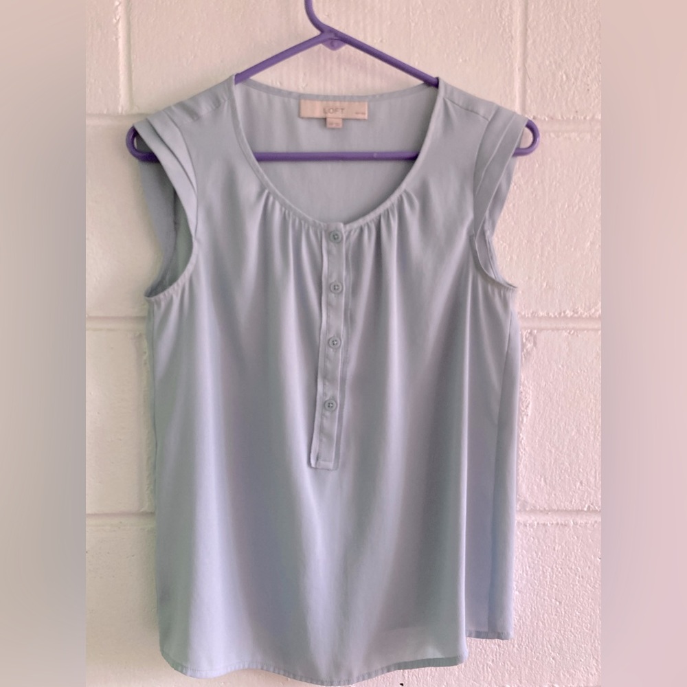 Sleeveless top with ruffled cap sleeve.